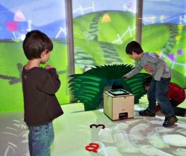 As Alphabot passes through a hole in the display panel, it appears to continue its journey through the virtual world projected onto the panels