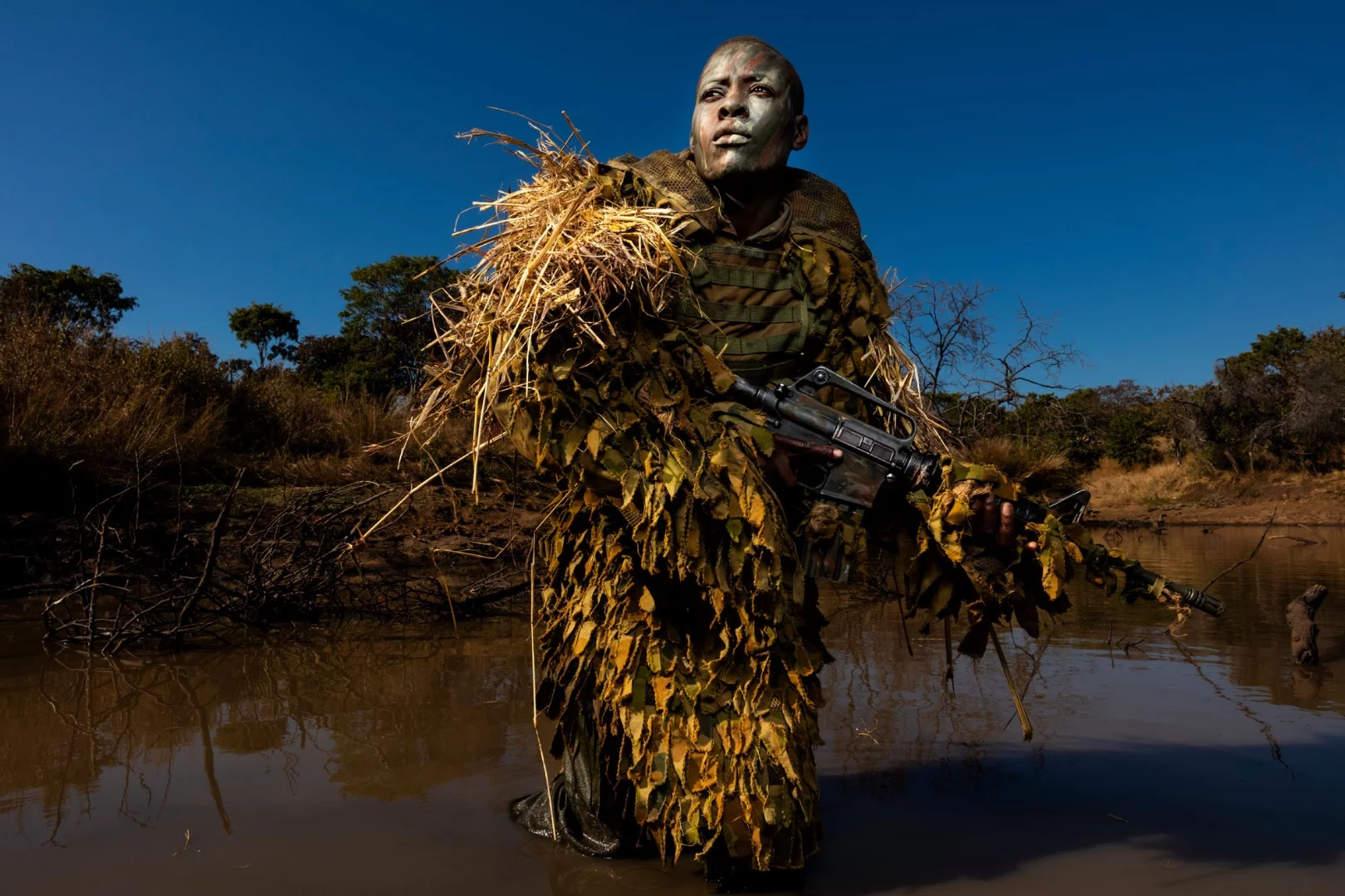 Petronella Chigumbura, 30, an elite member of the all-female Akashinga conservation ranger force undergoes stealth movement and concealment training in the bush near their base