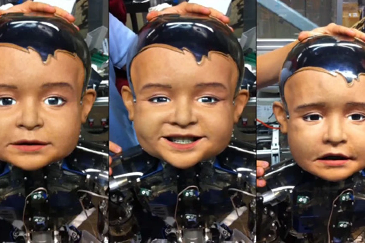 Diego-san, an expressive infant robot developed for UCSD's Machine Perception Lab, makes faces for the camera