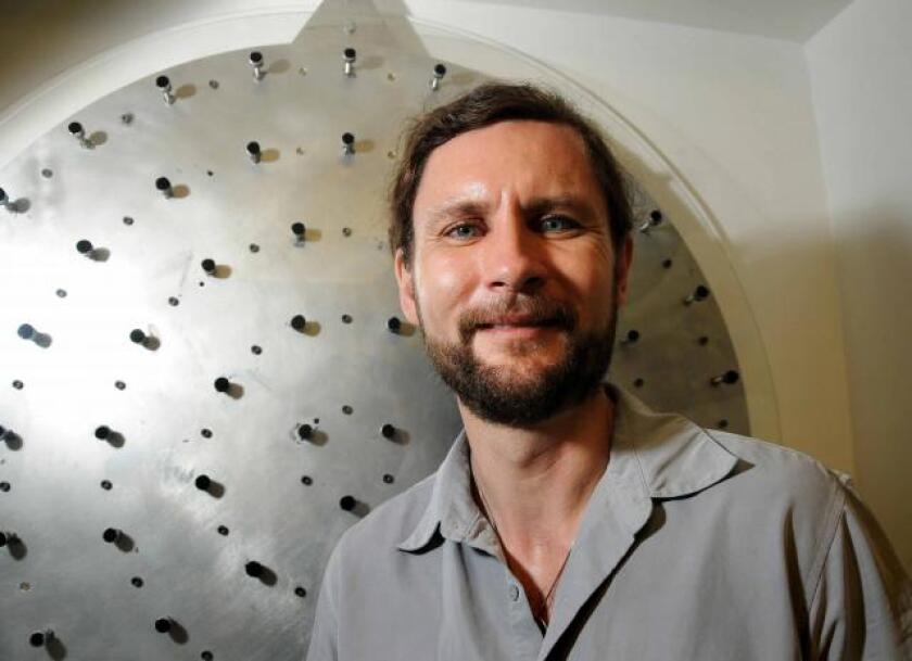 Laser Adaptive Optics study leader Michael Hart, in front of a prototype of the adaptive mirror