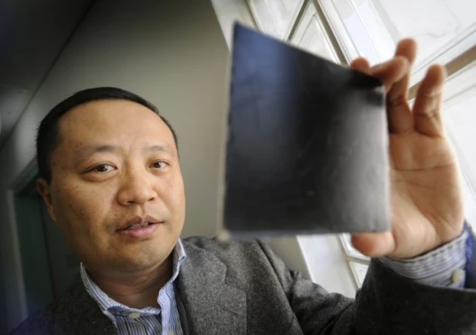 Dr Chan inspecting a small piece of the nanocomposite material.
