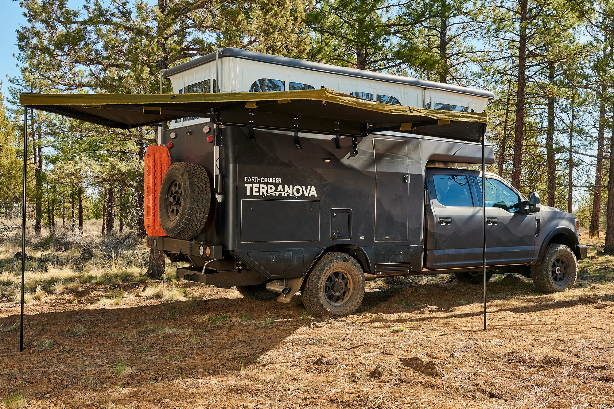 EarthCruiser Terranova with available awning set up and ready to camp