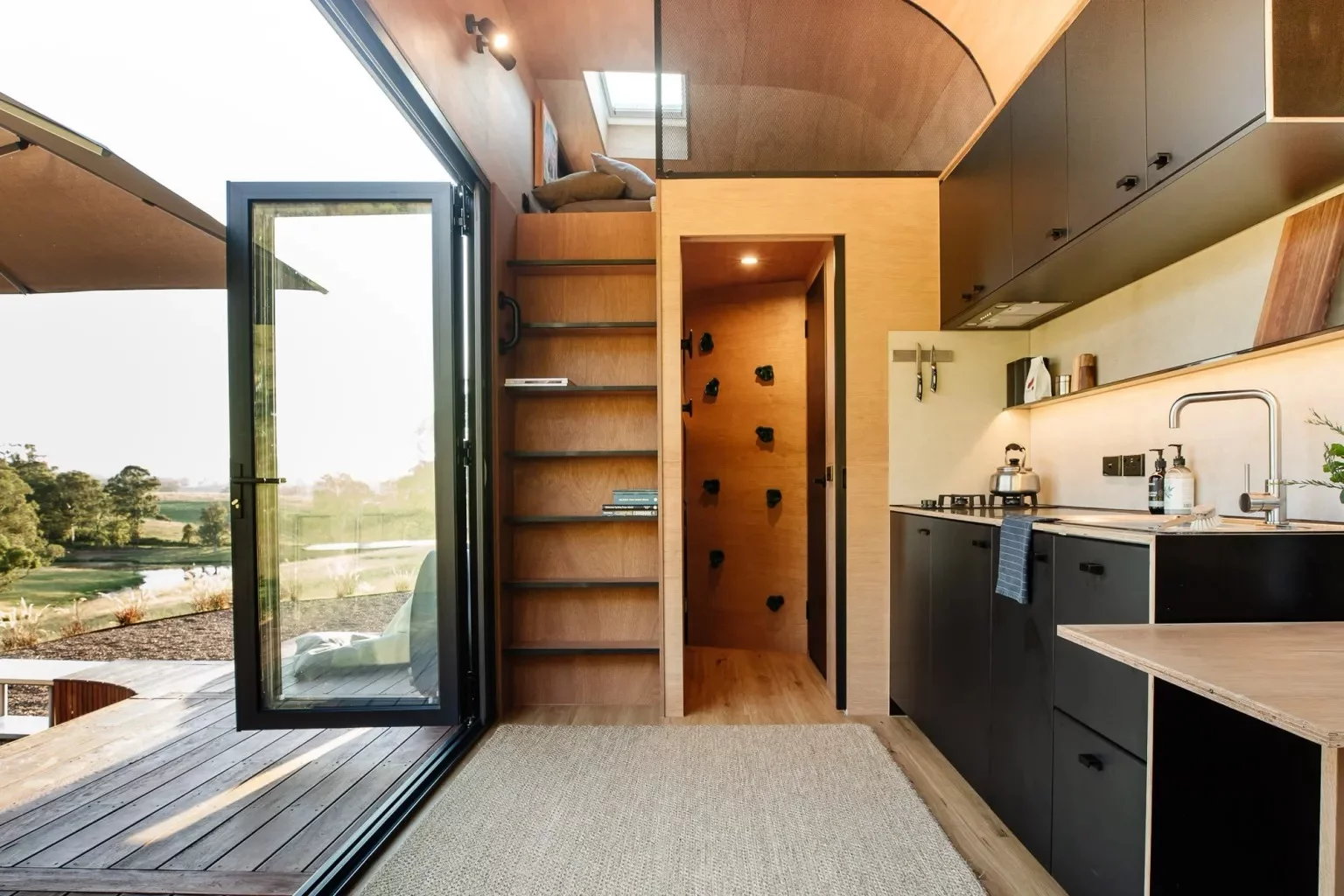 The Fowler & Ward x Base Cabin's bunk bed is accessed by a small climbing wall