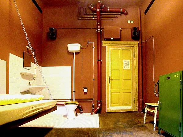The Prison Cell Room with an exposed toilet in the center