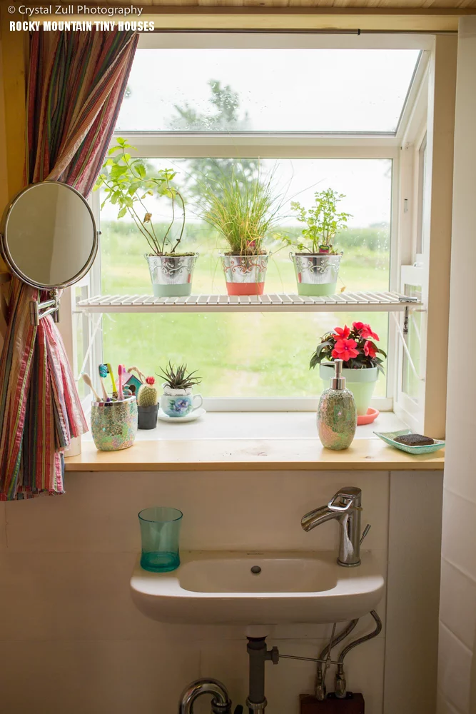 A garden window juts out from the bathroom