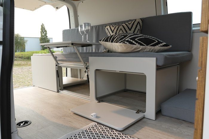 Bullifaktur's main sofa-bed unit includes storage in the frame and an available front panel that doubles as a dining table