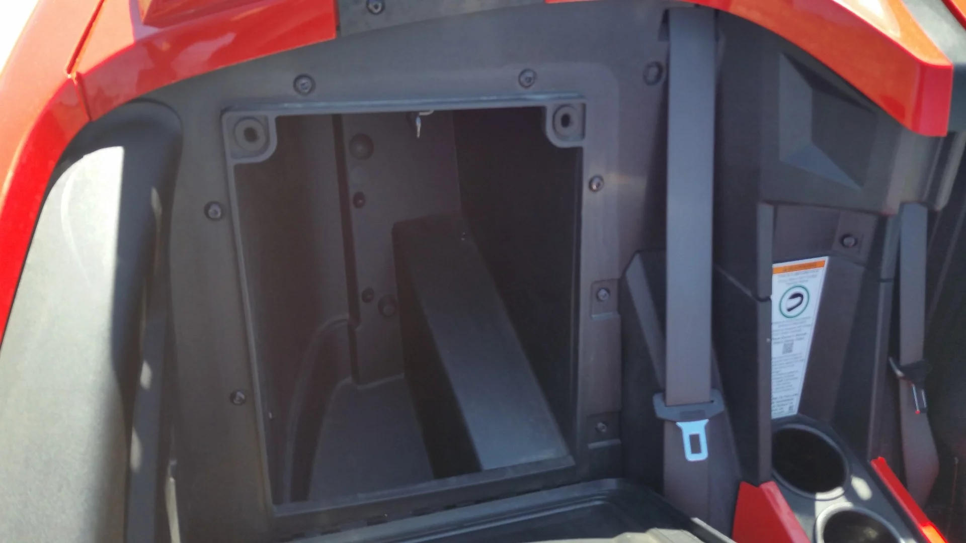 A surprisingly generous sized storage compartment behind each seat is big enough for a couple of helmets or a small overnight bag