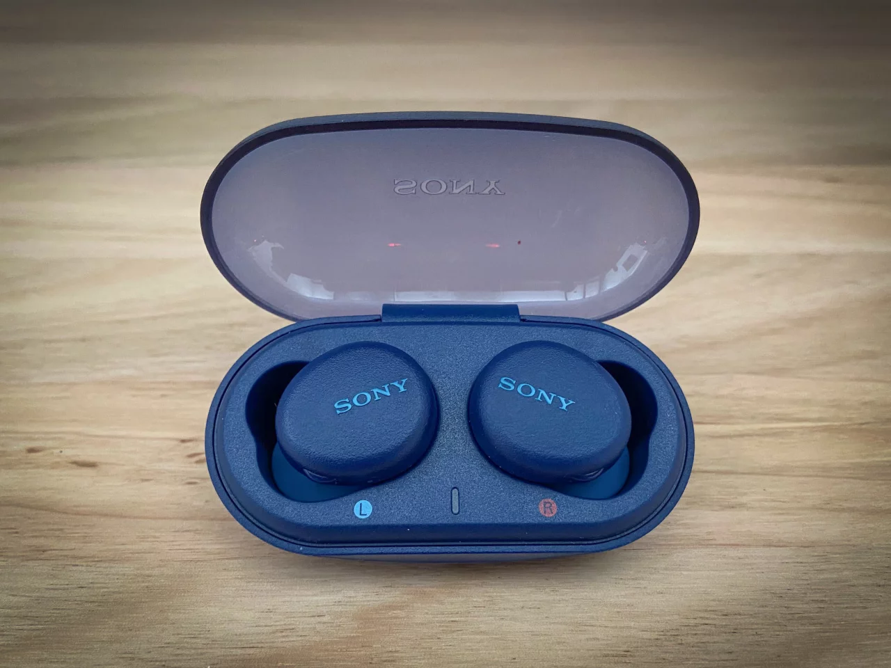 The earbuds sit snugly in the solidly built charging case