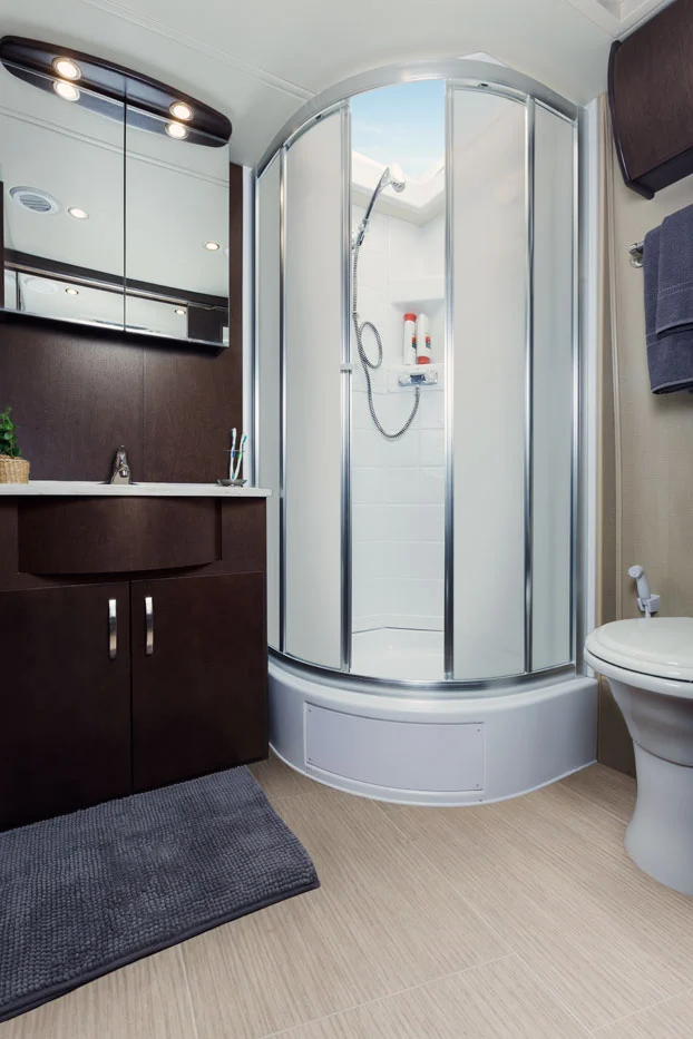 The roomy rear bathroom includes a corner shower with skylight