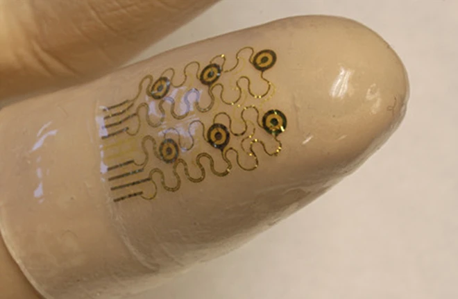 A newly-developed electronic finger cuff could lead to smarter surgical gloves that make performing surgery and scans as easy as pointing your finger (Image: John Rogers/University of Illinois)