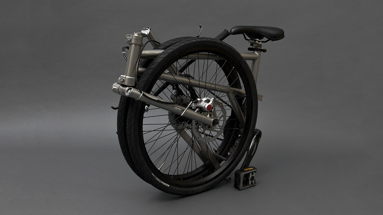 Those wheels still turn when the bike is folded, allowing it to be carted along like wheeled luggage