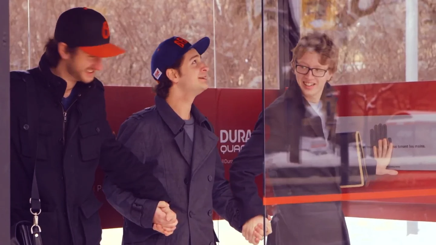 Some Montrealers enjoy some warmth provided by the bus shelter