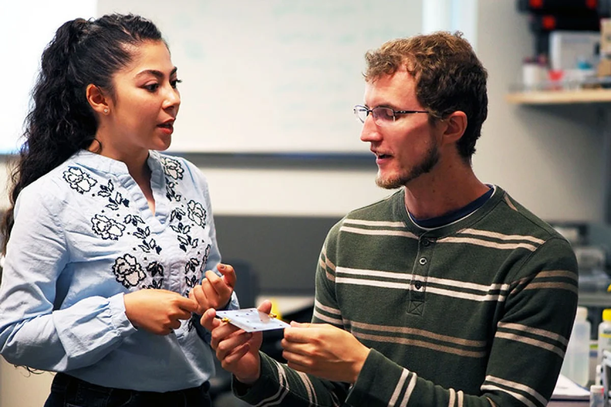 Graduate students Kiana Mirshahidi and Ben Wiltshire, with one of the sensors