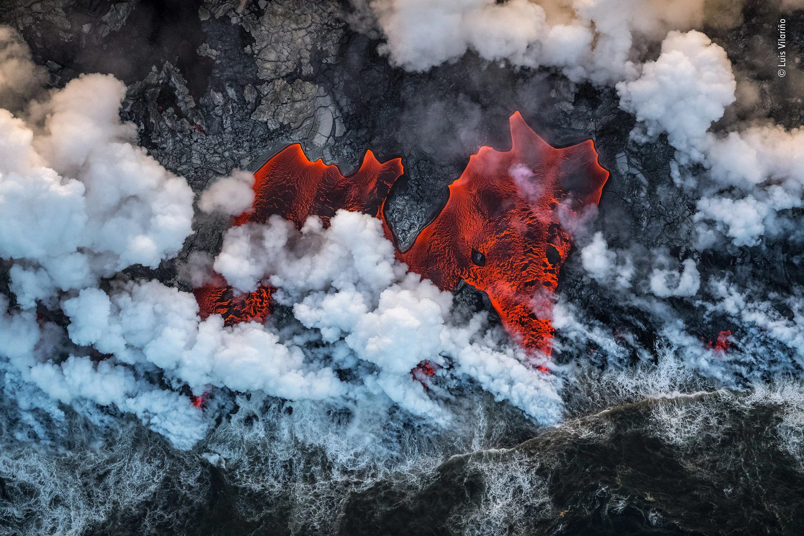 Winner - Earth’s Environments. Red-hot lava tongues flow into the Pacific Ocean, from the biggest eruption for 200 years of one of the world’s most active volcanos – Kîlauea, on Hawaii’s Big Island
