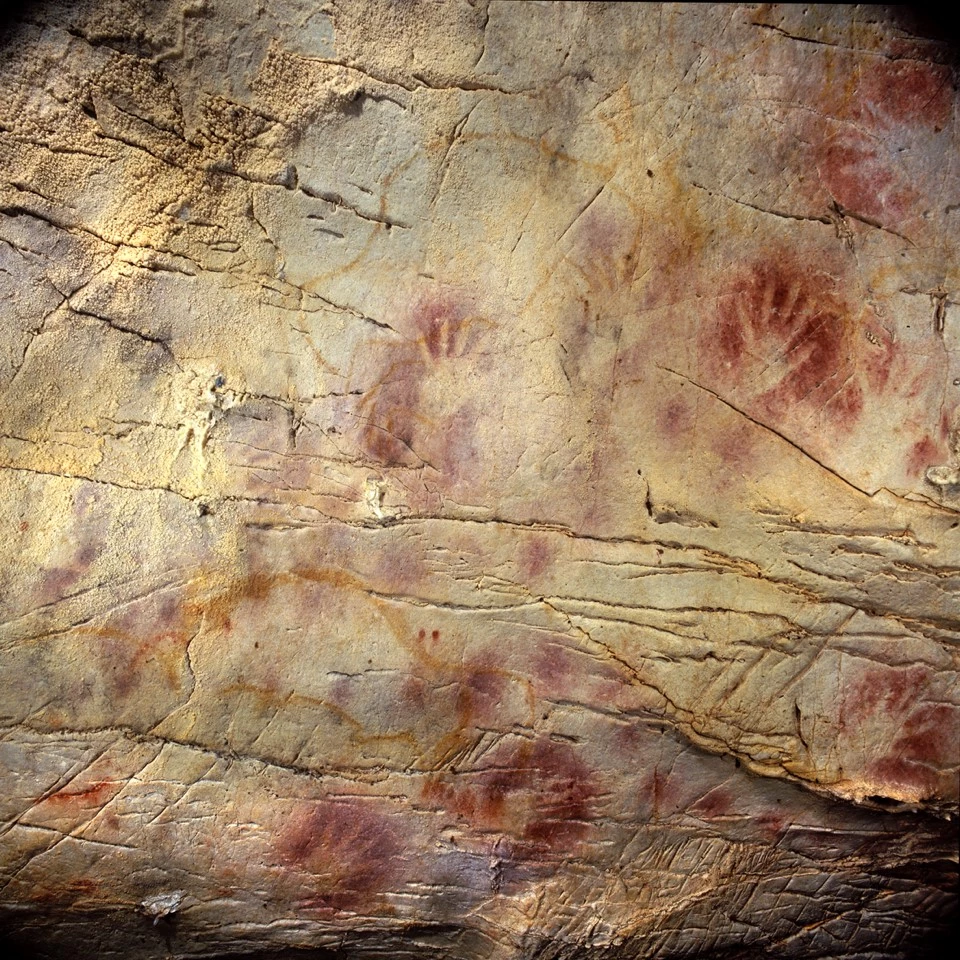 Handprints in red ochre – which may have been used as an ancient form of sunscreen – are a common cave art motif. The centre of this cave art from Spain is believed to be almost 42,000 years old.