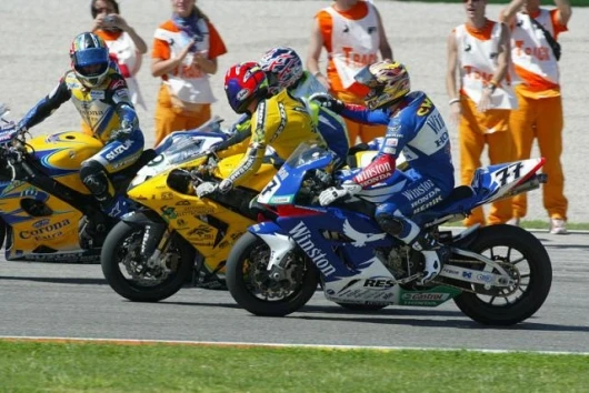 The end of race two and Troy Corser is congratulated by Chris Walker and Chris Vermeulen
