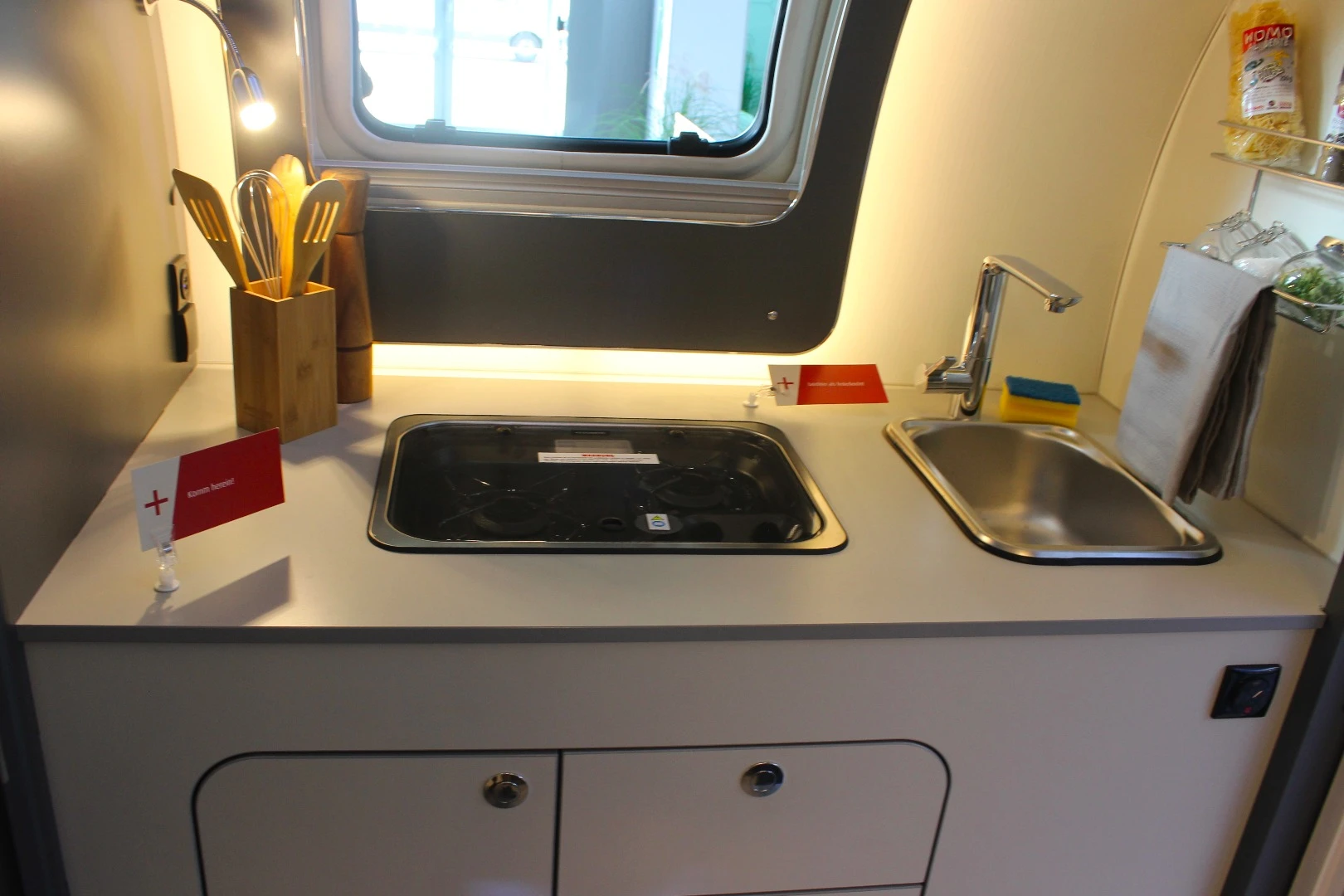 The kitchen block has a dual-burner stove and sink