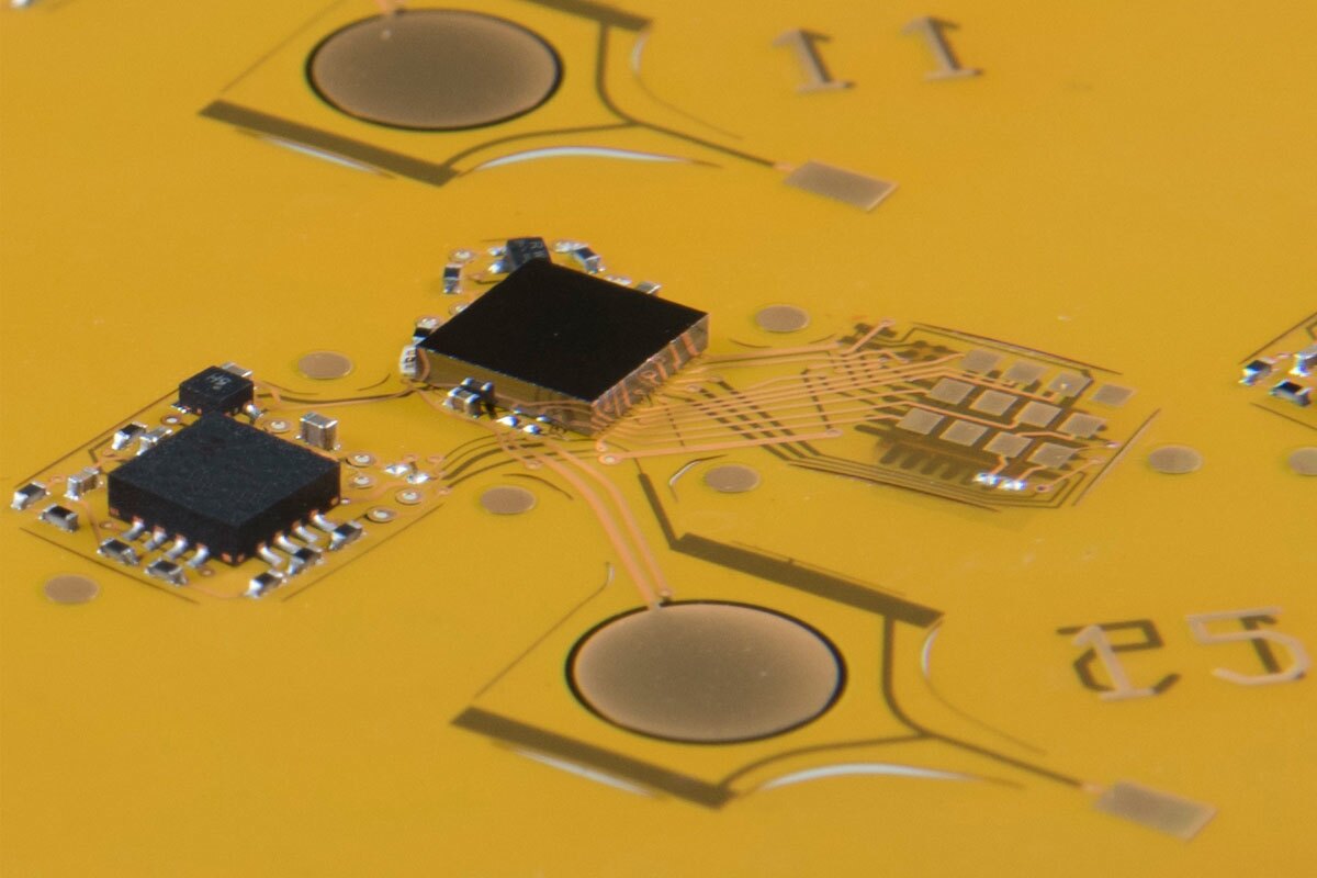 The DragonflEye system and components laid flat, before they're folded up and fitted to a live dragonfly
