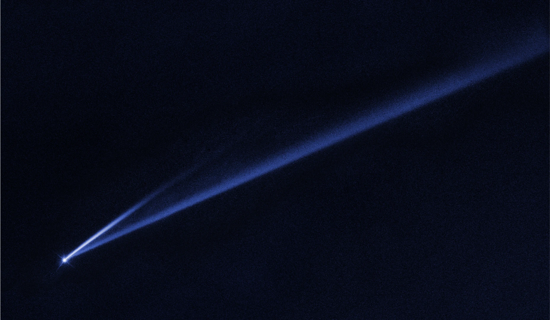 A Hubble Space Telescope image revealing the gradual self-destruction of an asteroid, whose ejected dusty material has formed two long, thin, comet-like tails