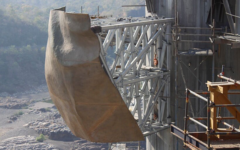 The first bronze panel being installed