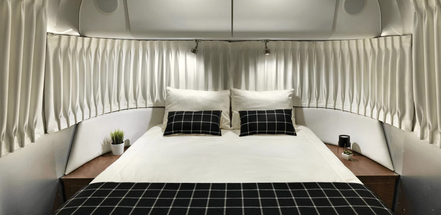 Made to sleep up to six people, the Airstream Globetrotter's bedroom features an adaptive foam mattress surrounding by curvy, low-profile panoramic windows