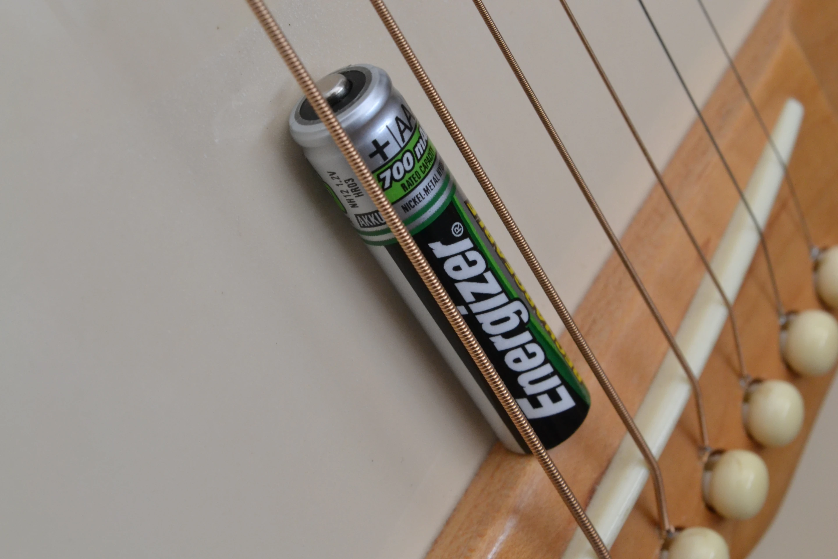 If you can roll an AAA-sized battery under the strings at the bridge, and there's more than three inches of depth within the body, your guitar should be compatible with the Vo-96