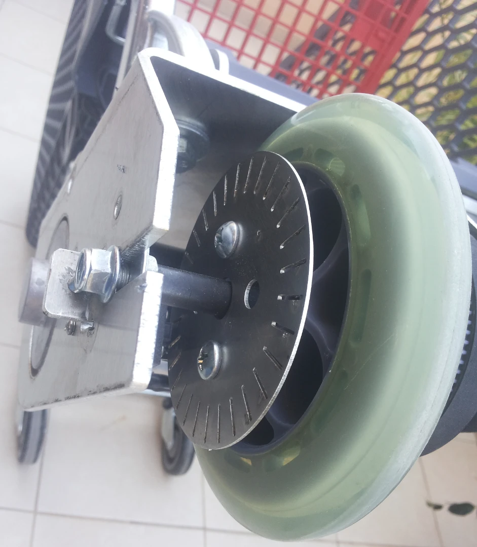 The modified rear-left wheel that drives the electric trolley