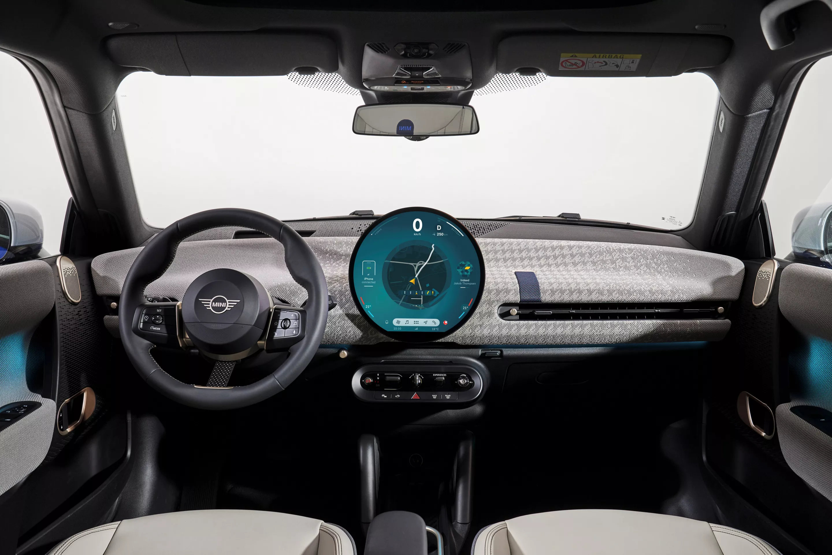 The round OLED display serves as a digital instrument cluster and entertainment hub