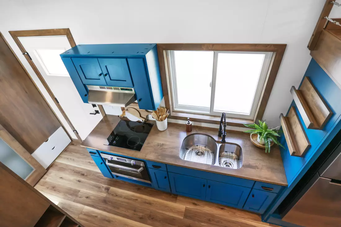 Mi Casita's kitchen includes a double sink, an electric oven and cooktop, plus a microwave