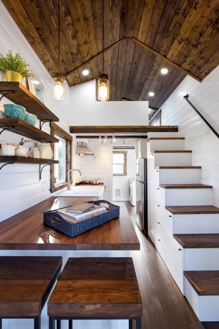 There is a built-in bar table incorporated into the kitchen, with two stools that tuck away neatly beneath the kitchen bench