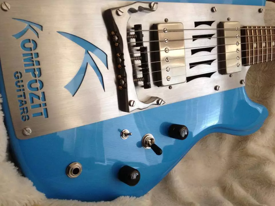 Close up of The Two's proprietary custom bridge, a 3-way pickup selector, a pickup split switch, and volume and tone knobs