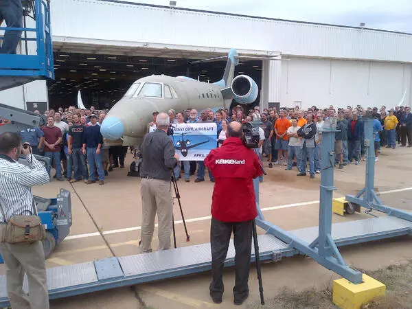 Cessna employees say cheese alongside the first production new Citation X