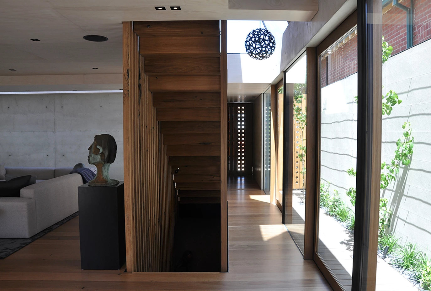 Recycled tallowwood was used for the home's interior flooring, windows, staircases and striking external cladding (Photo: Edoardo Campanale for Gizmag)
