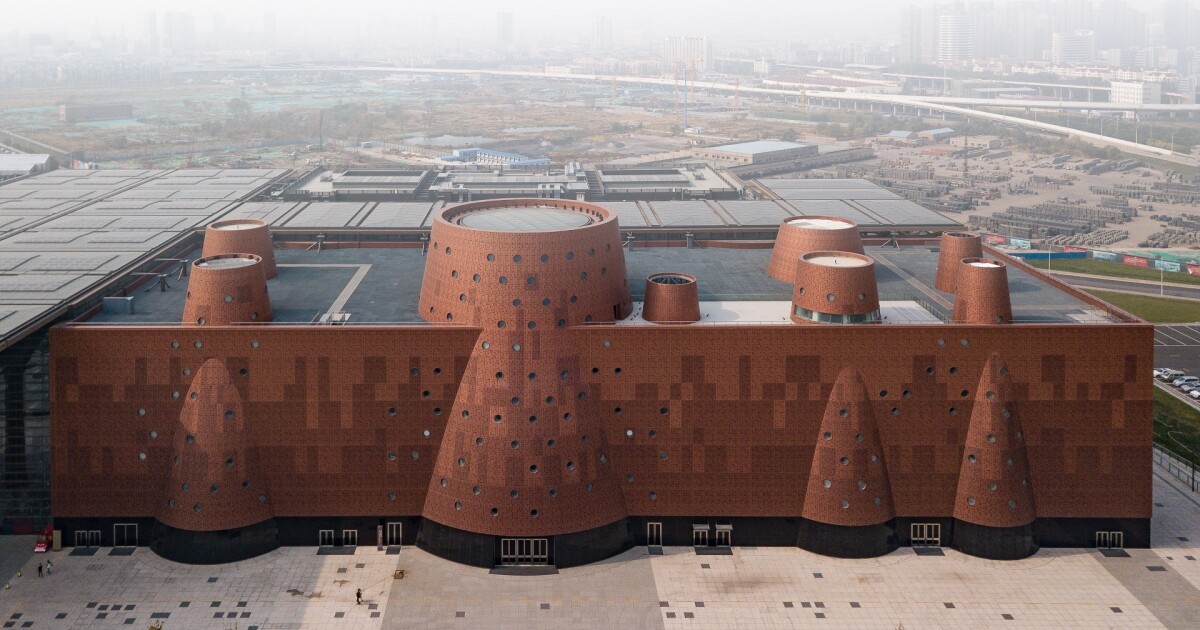Perforated, portholepacked facade peeks into China's technological history