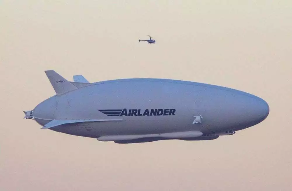 The Airlander 10 airship, seen here on its maiden flight with a helicopter escort