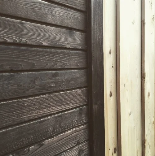 The exterior of the 26-ft-long Legacy tiny house is lined with cedar siding matched with contrasting Shou Sugi Ban-style charred cedar trim