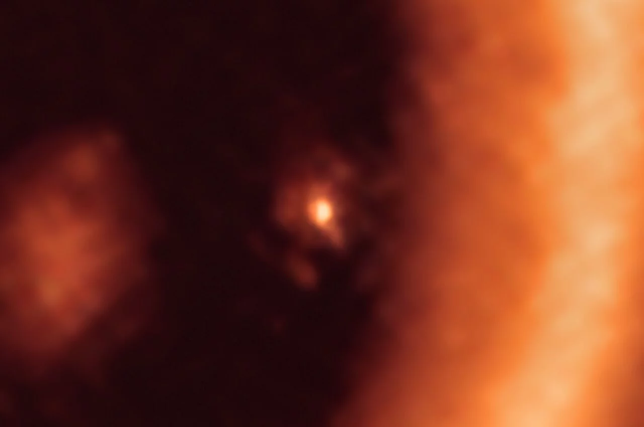 ALMA image displaying the circumplanetary disk surrounding the exoplanet PDS 70c in the center of the image, with the much larger circumstellar disk taking up the right hand side of the shot