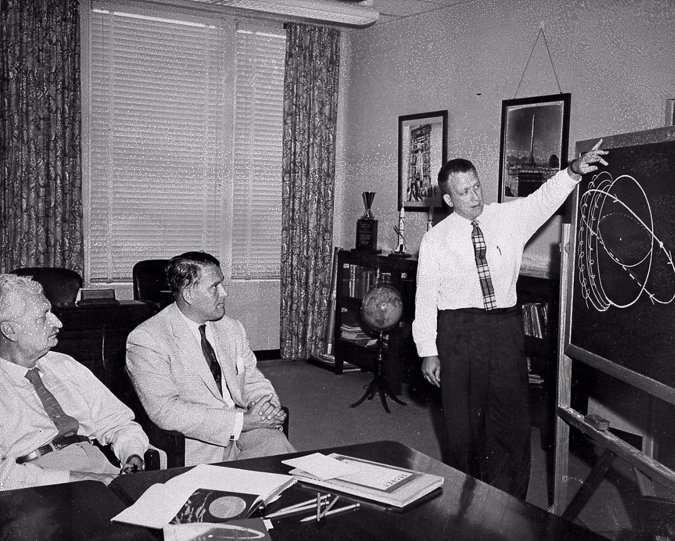 Wernher Von Braun and Hermann Oberth studying orbital trajectories