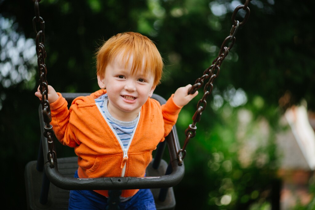 You might need more focal length reach and a larger maximum aperture to keep up with the kids