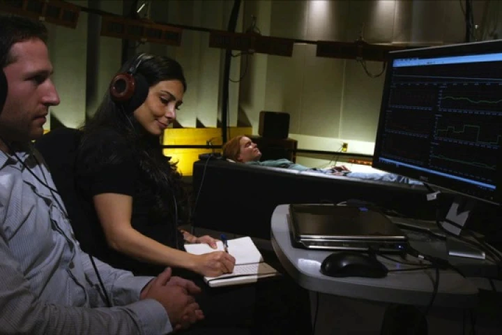 Researcher Valorie Salimpoor and colleague Mitchel Benovoy observe a volunteer as she listens to some of her favorite music