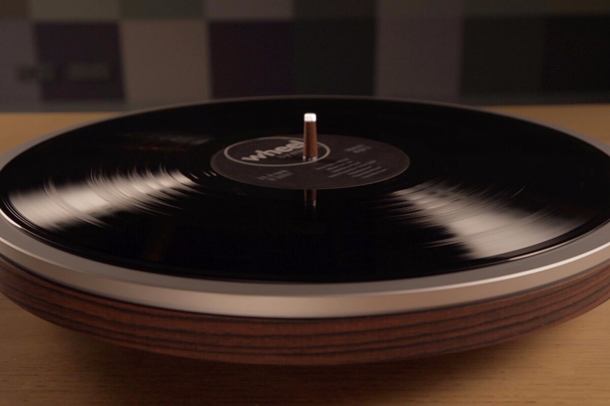 The underside of the record is played using a tonearm and cartridge mounted within the body of the Wheel turntable