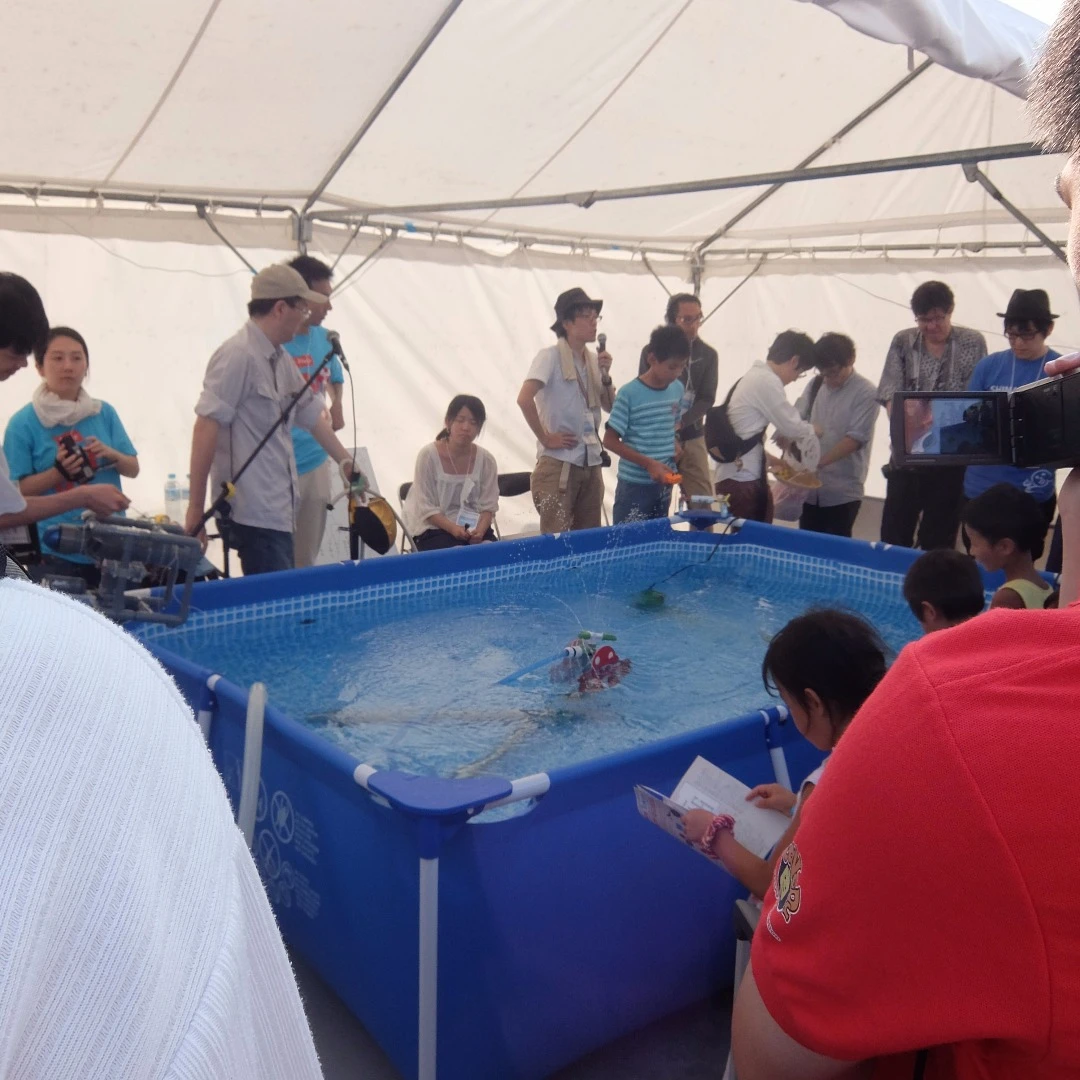 Maker-made watercraft negotiating the "rapids" at the Faire