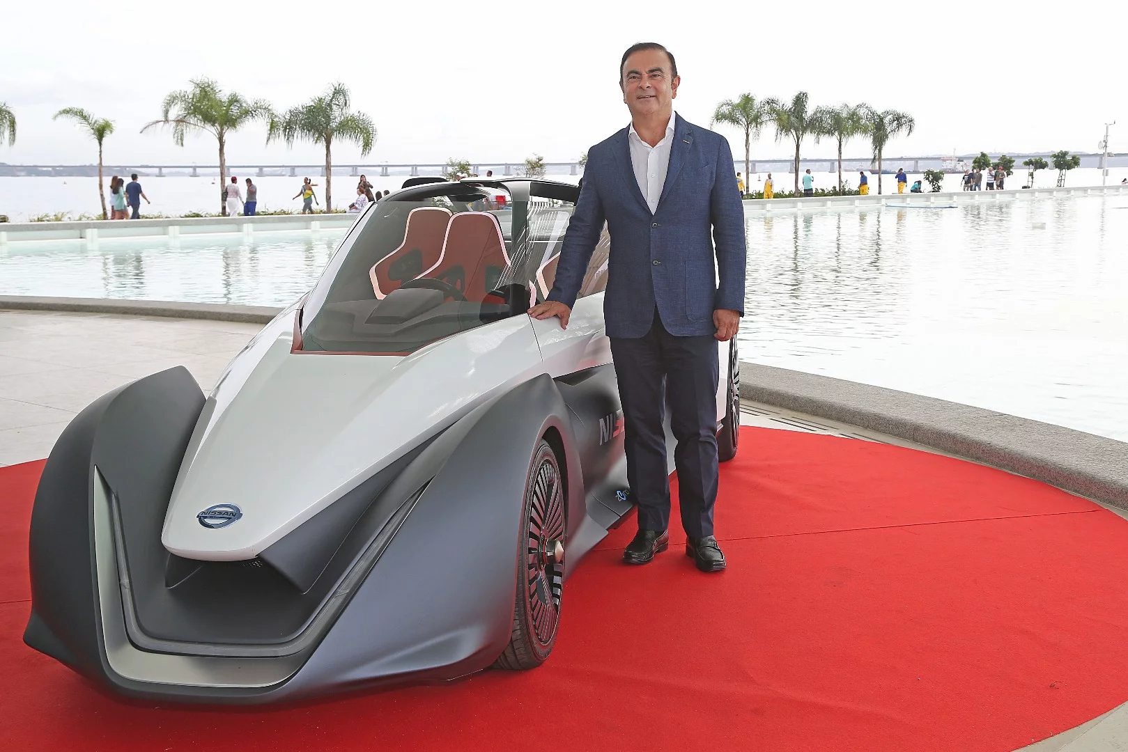 Nissan CEO Carlos Ghosn poses next to the BladeGlider concept unveiled in Brazil
