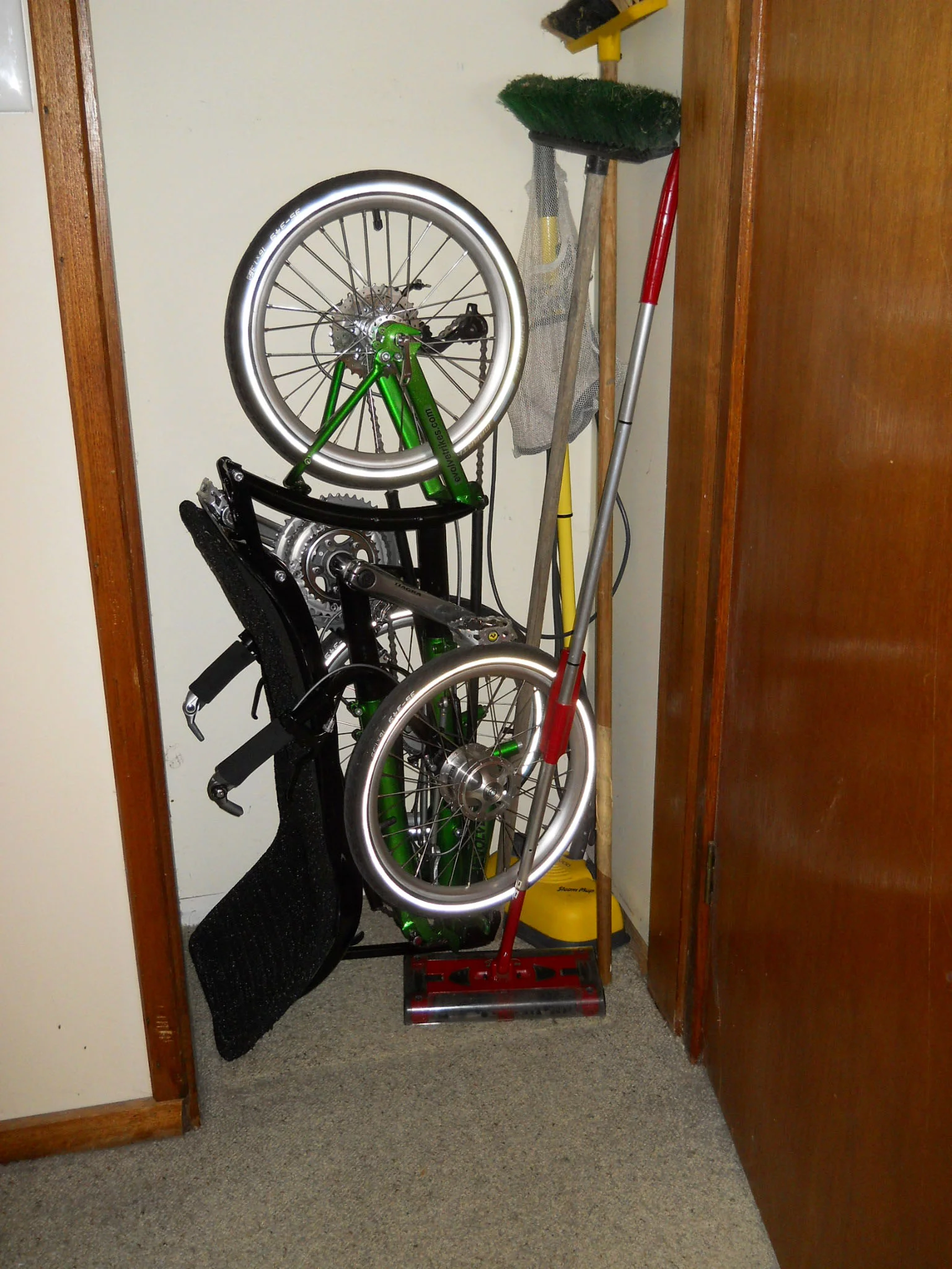 The Evolve trike, stowed in a broom closet