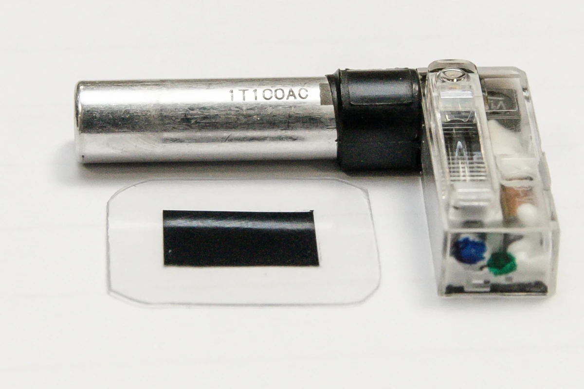A typical smartphone flash with its existing capacitor (silver cylinder), and the new polymer capacitor material (lower left)
