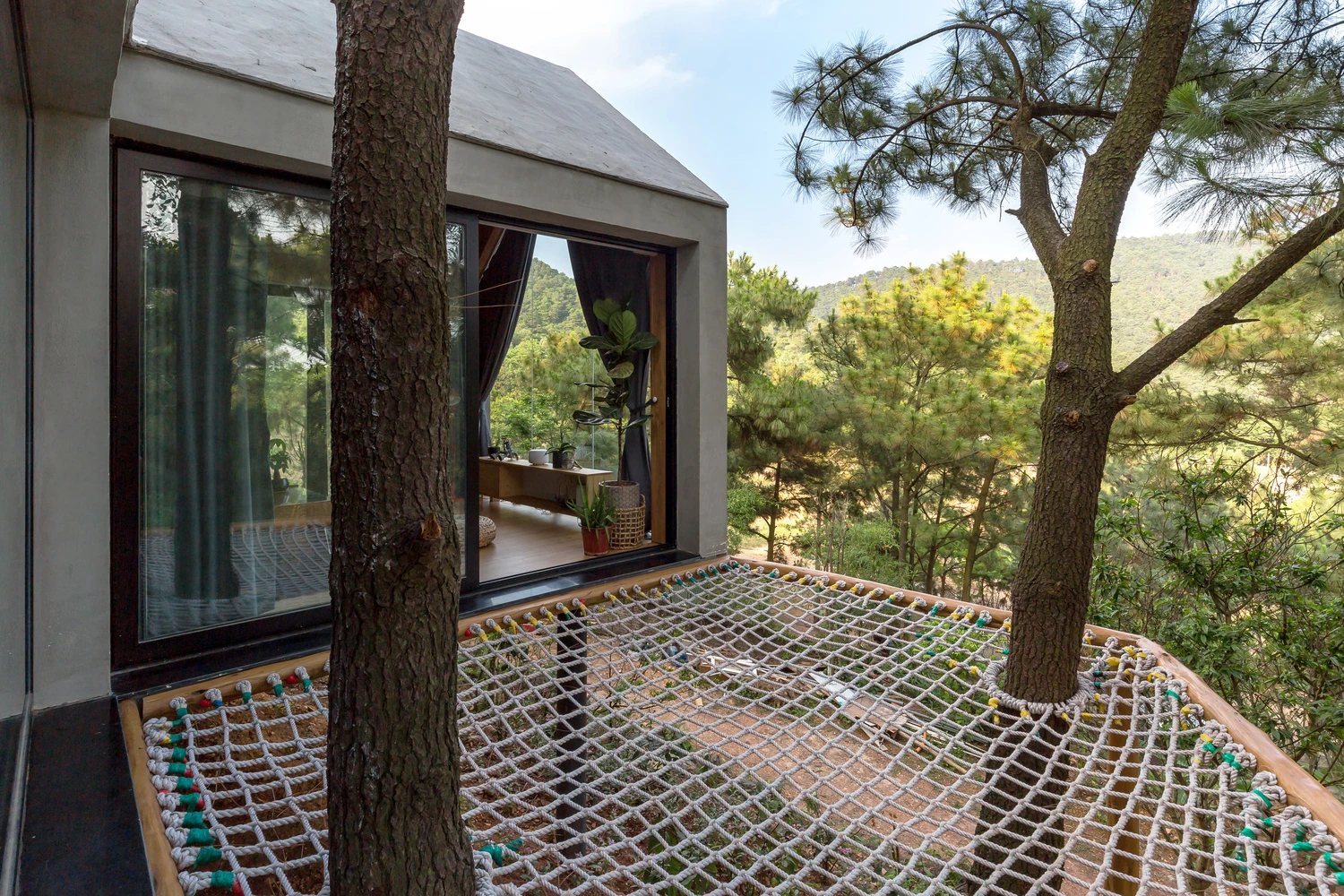 Forest House 02 is surrounded by vast forest landscape in the Sóc Sơn District, 30.6 km (19 mi) outside of Hanoi, Vietnam