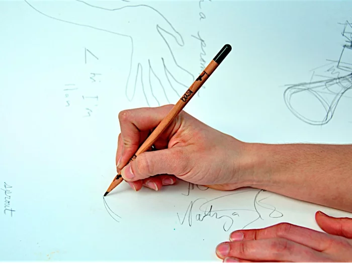 Sprout being used as a pencil, with the seed sitting in the tip waiting for its big moment