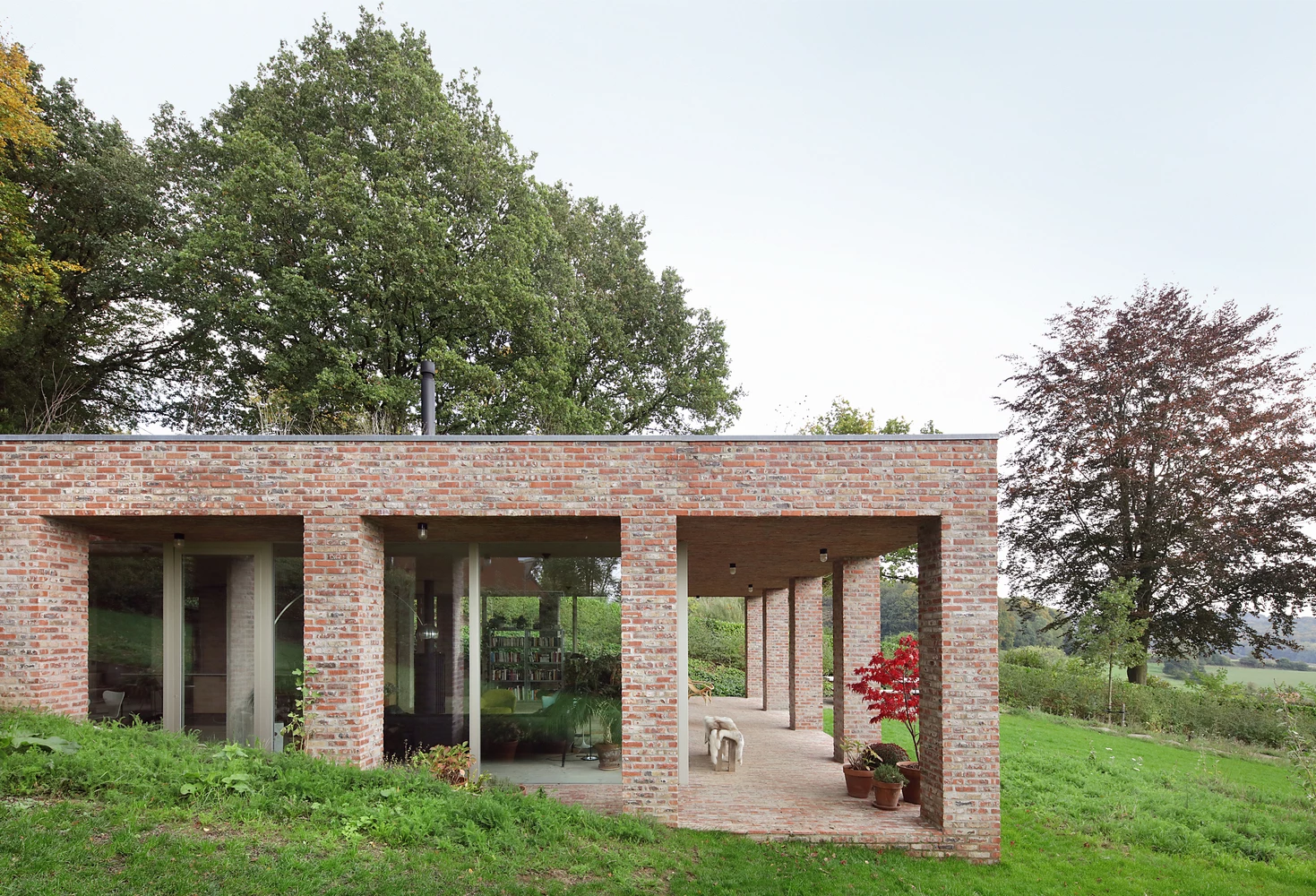 Studio Okami came up with an “invisible house” design, which saw the home built into the sloped terrain