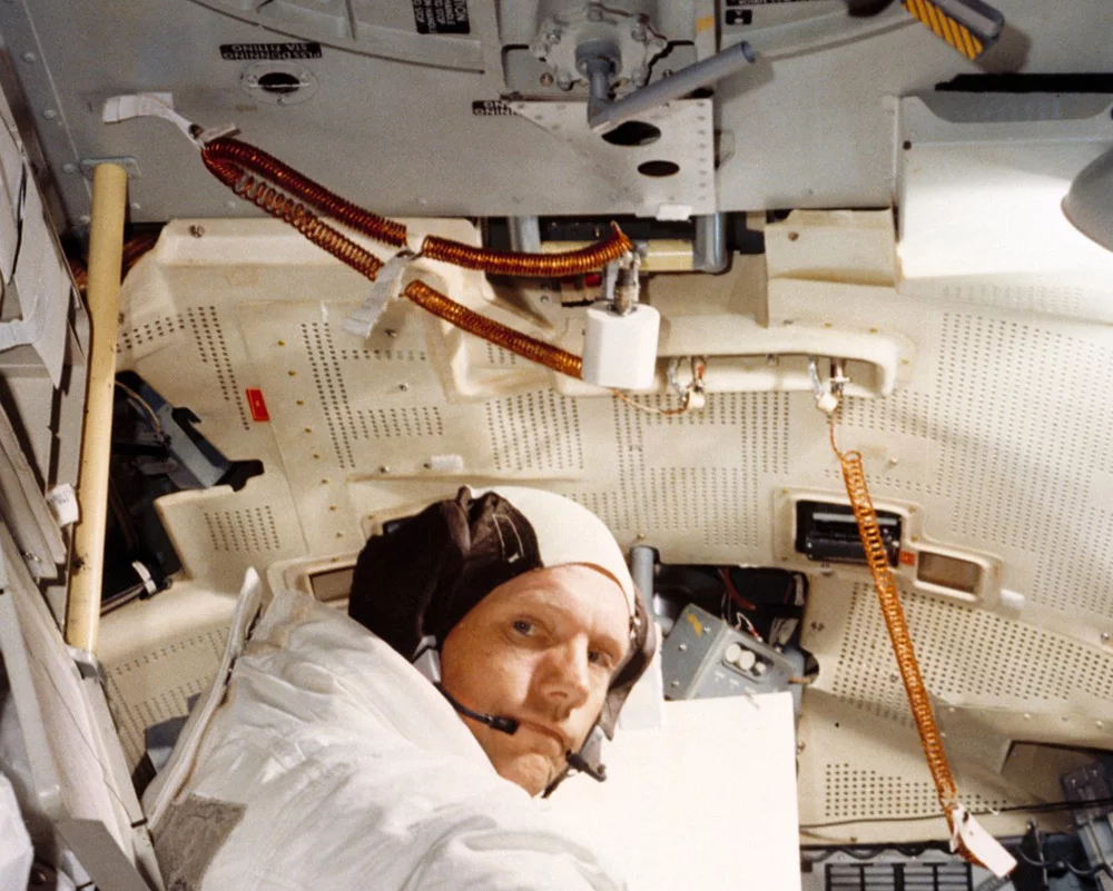 Neil Armstrong in LM simulator with utility light positioned above (Photo: NASA)