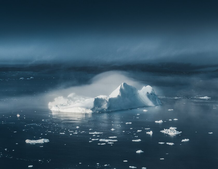 In the lower left-hand corner of this image one can spy a ship giving a sense of scale to these massive icebergs